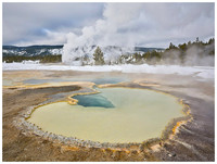 Hot spring and erupting geyser, Winter, Yellowstone NP, Wyoming